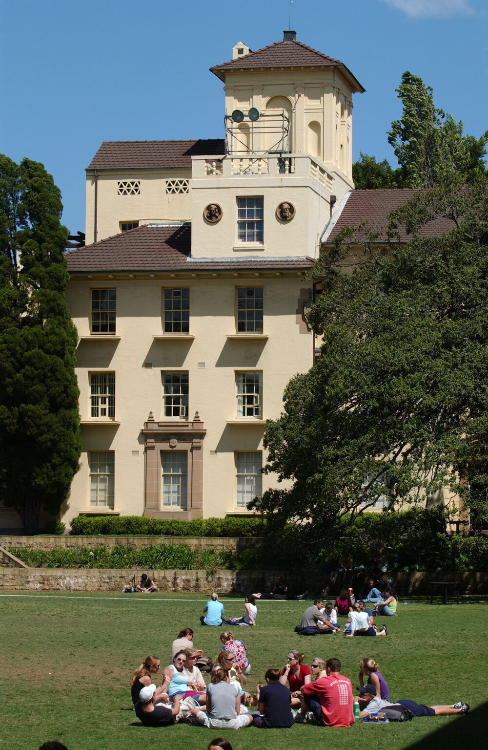 Students Relaxing on The Square, with a View of Physics Building
