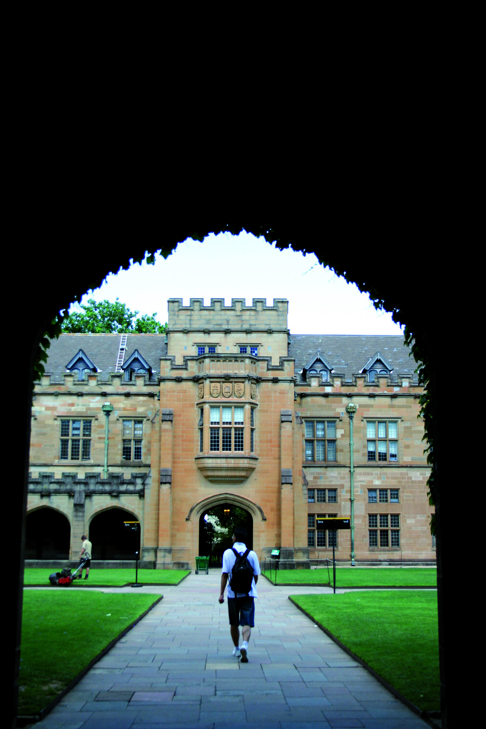 Student Walking Through Quadrangle Main Entrance