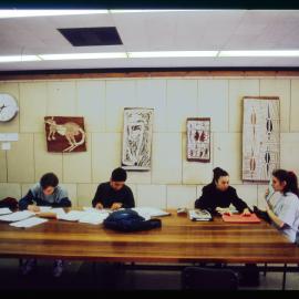 Students Sitting at Large Table in Fisher Library Foyer