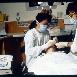 Dental Students with Patient in Clinic for Four-Handed Work