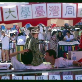 Stalls at Orientation/O-Week with a Student in Army Reserve Uniform Walking Through