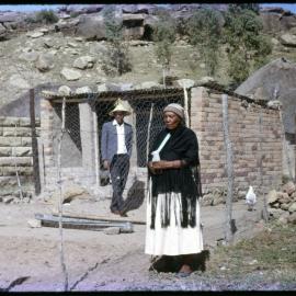 Man and Woman Outside Chicken Coop