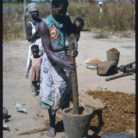Woman Using Mortar and Pestle