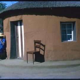 Woman Sitting Outside Building