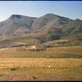 View Over Land with Buildings and Mountains