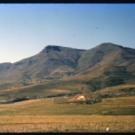 View Over Land with Buildings and Mountains