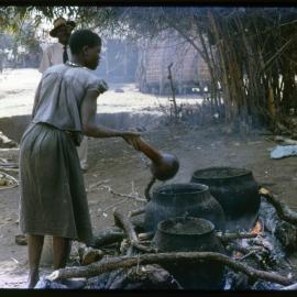 Pots of Food Cooking Over Fire