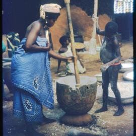 Woman and Boy Using Mortar and Pestle