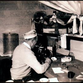 Professor Spencer (Spinny) Smith-White Looking Into a Microscope