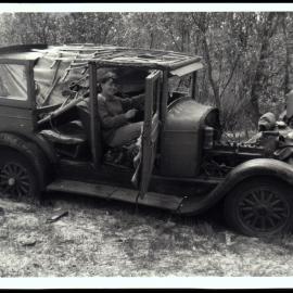Jan Jacobs Sitting in Wrecked Car