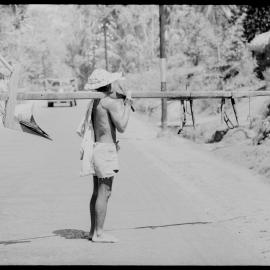 Man Carrying Wooden Equipment