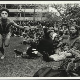 Aboriginal Dancer in Front of a Watching Crowd with Didgeridoo Player at the Back