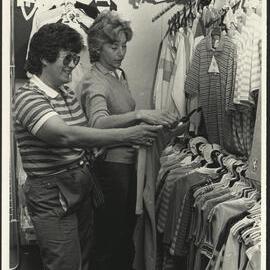 Two Women Looking at a Shirt in the Sports Store of the Sports Union