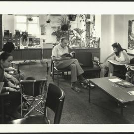 Students and Staff Sitting in the University Health Service Waiting Room with Reception Desk in Background