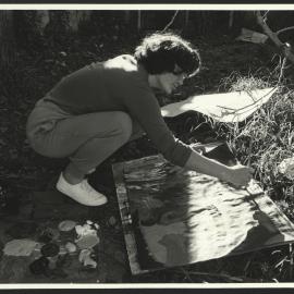 A Student Painting a Picture or Poster in the Outdoors at an Art Workshop