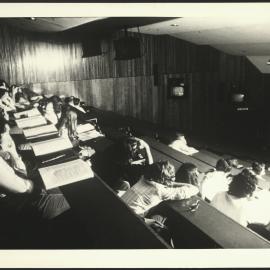 Students in a Lecture Room with Closed-Circuit Television Set Up in the Room
