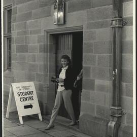 A Female Student Leaving the Student Centre in the Main Quadrangle