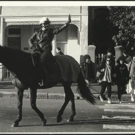 Student Foot Traffic to the University with Traffic Regulated by Police on Horseback