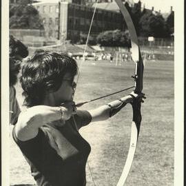 A Female Student Demonstrating Archery