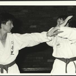 Two Students at Practice During a Martial Arts Class at the HK Ward Gymnasium
