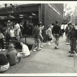 Students Standing and Walking Near the Entrance to the Carslaw Building