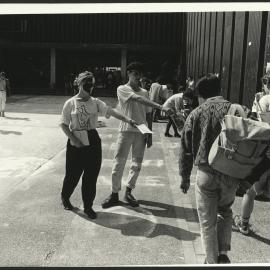 Students Distributing Flyers Outside Fisher Library