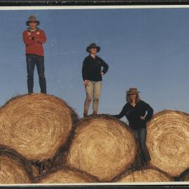 School of Crop Sciences Students Paul Minogue, Mary Goodacre and Diane Munnich Standing on Hay Bales