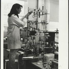 Agriculture Student Setting Up an Experiment on Scientific Apparatus