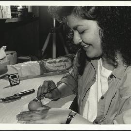 Biology - Student Cutting a 'Window' into a Chicken Egg for an Embryology Experiment