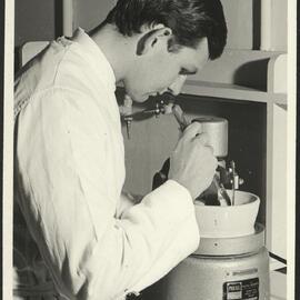 Pharmacy Laboratory - Student Using Automatic Mortar and Pestle