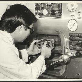 Pharmaceutical Chemistry Laboratory a Student Placing a Wire Basket with Medicine (?) into an Autoclave