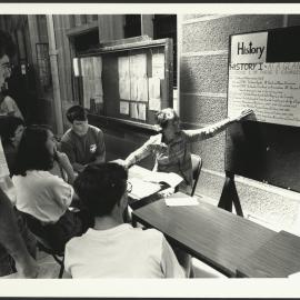 Enrolment Time - Directional Signage in the Cloisters and Lecturer Providing Information on History