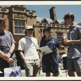 University Volunteer Assisting Prospective Students Standing in the Quadrangle at Information Day 1999