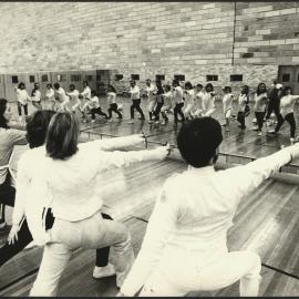 Sport and Recreation - Students Practicing Fencing in Front of a Mirror