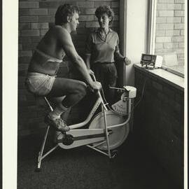 Sport - Health Monitoring Student on an Exercise Bike Being Monitored