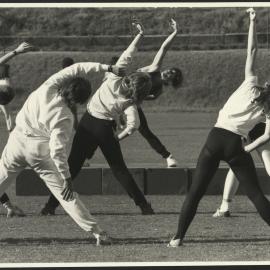 Sport and Recreation - A Group of Women Undertaking Stretching Exercises on the Oval