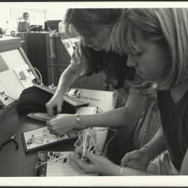 Two Women Electrical Engineering Students at Workbench