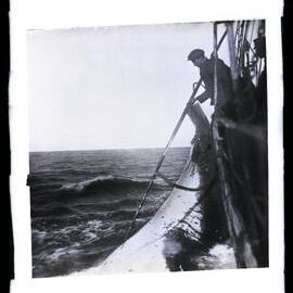 Man Leaning over Ship