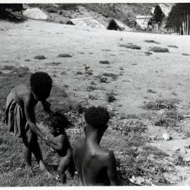 Adult and Two Children Standing Near Hamlet