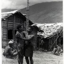 Two Men Standing in Front of Buildings