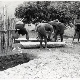 Men Preparing a Log Coffin