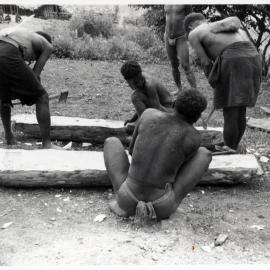 Men Preparing a Log Coffin