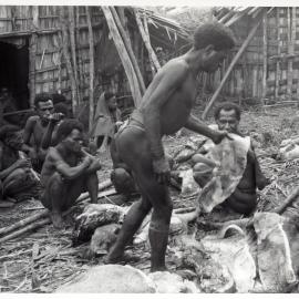 Group Preparing Pigs for Ceremony