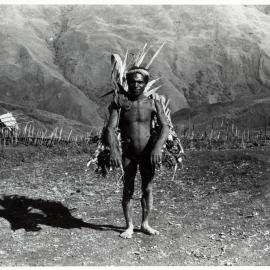 Man Carrying Bags of Logs