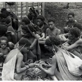 Group Sitting, Some with Net Bags