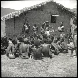 Group Seated Before Standing Men