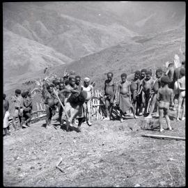 Man Digging With Shovel Before Group