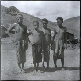 Group of Four Standing in Front of Hamlet
