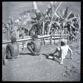 Men Seated, Facing Fence