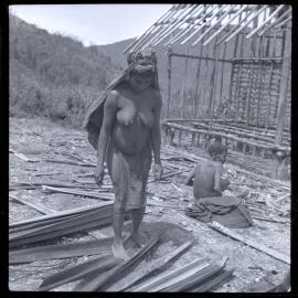 Woman Standing in Front of Partially-Constructed Building